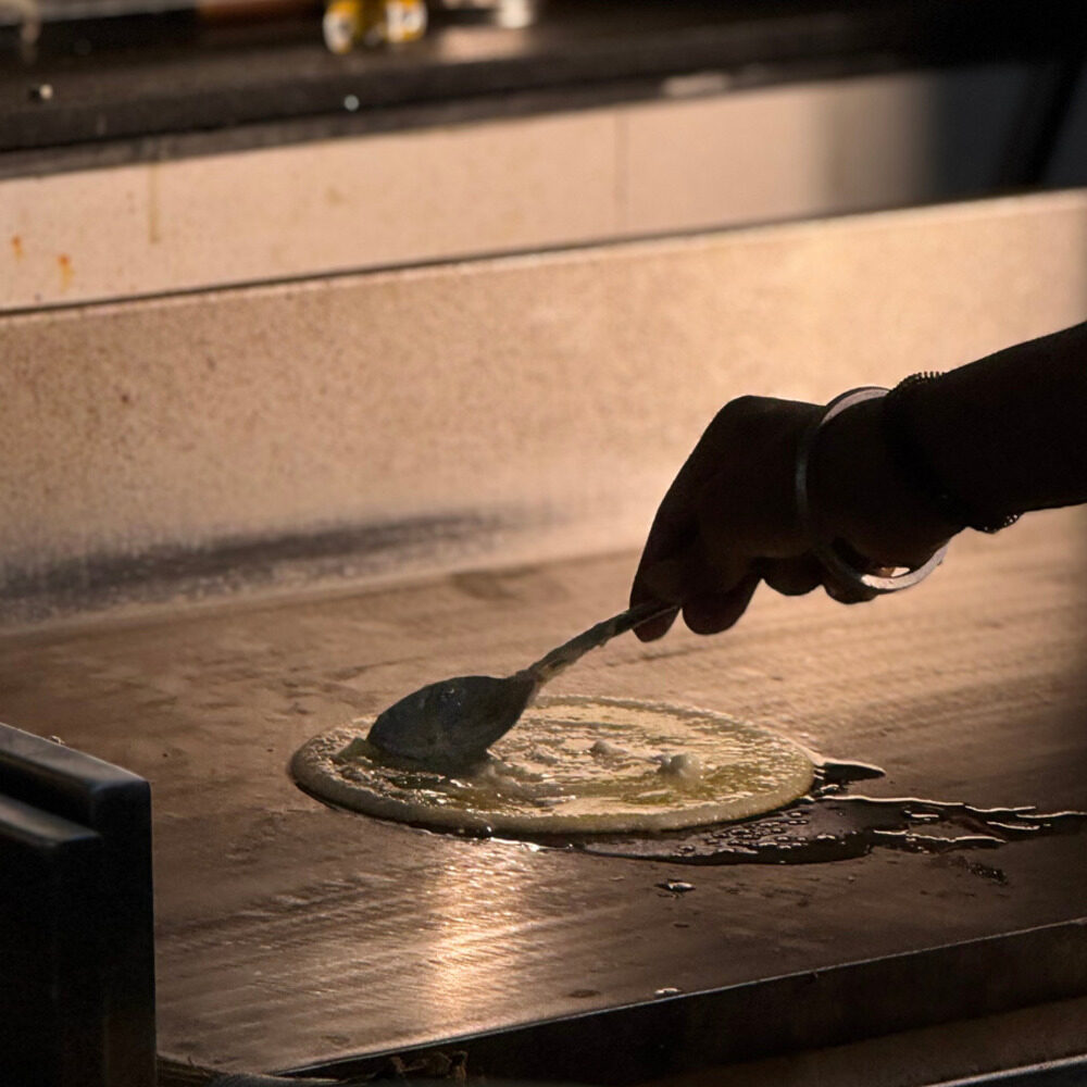 Dosa being made on the tawa at Podikka